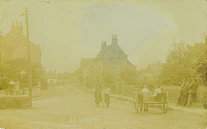 Early postcard of Low Street and the Market Cross